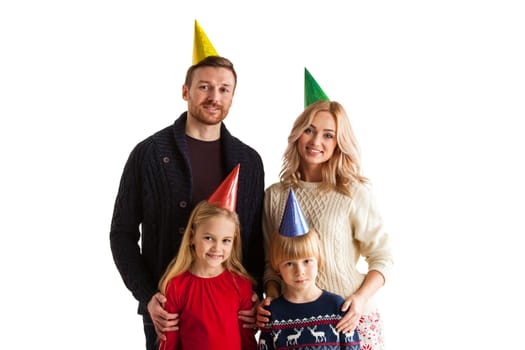 Portrait of happy party family in cone hats isolated on white background