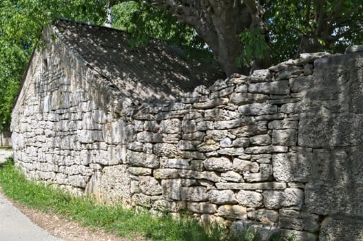 Mediterranean style stone house and fence