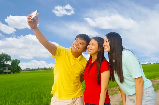 happy young teenager taking selfie in the park