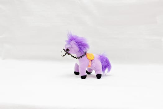 Souvenir soft horse pony violet isolated on white background.