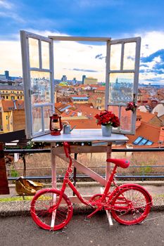Idyllic Zagreb upper town Christmas market decorations, view through window on city rooftops and bicycle view, capital of Croatia
