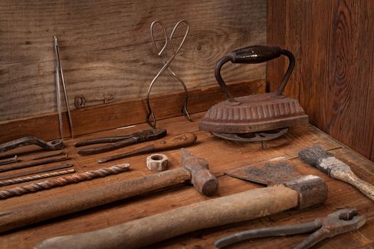 Collection of vintage tools on a blue wooden background: scissors, pliers, screwdriver. Repairing, craftsmanship and handwork concept, flat lay.