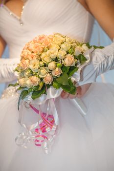 Wedding bouquet with roses on a wooden bench