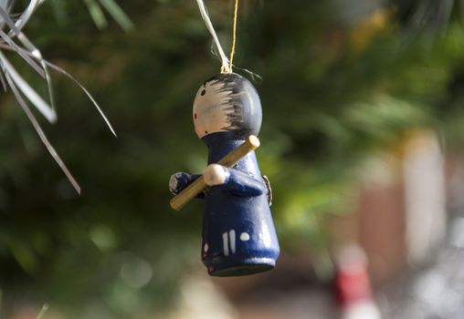 shepherd ornament hanging on christmas tree. Beautiful close up holiday photo. 
