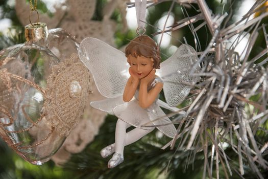  Angel ornament on christmas tree. Beautiful holiday photo. 
