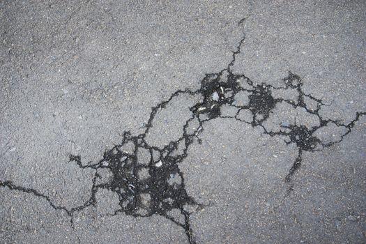 Cracked road alphalt texture, broken ground structure photo