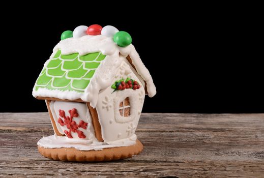 The gingerbread house on a wooden background