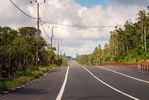 A big road to Grand Bassin lake at mauritius,background two huge staue of hindu religion.