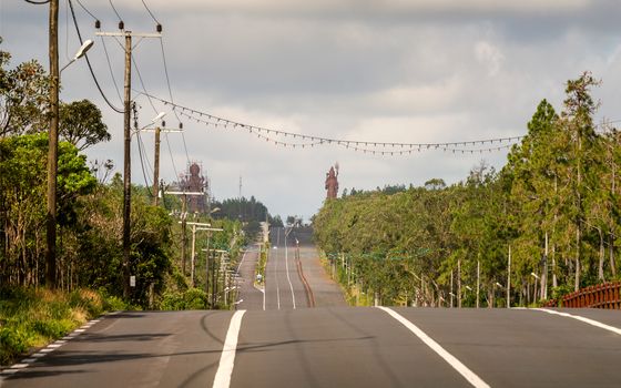 A big road to Grand Basin lake at mauritius,background two huge staue of hindu religion.