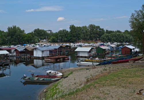 Boats and rafts sitting at Danube river dockside harbor