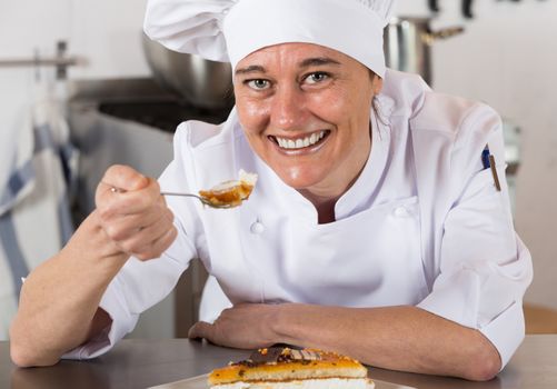 Pastry chef testing a yolk and cream cake