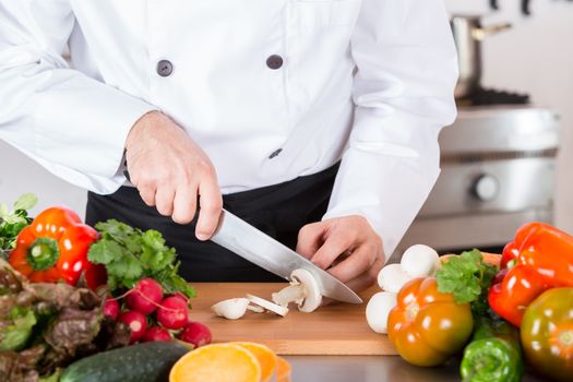 Chef cutting fresh and delicious vegetables for cooking