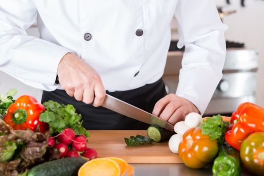 Chef cutting fresh and delicious vegetables for cooking