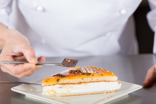 Pastry chef decorating cake yolk and cream