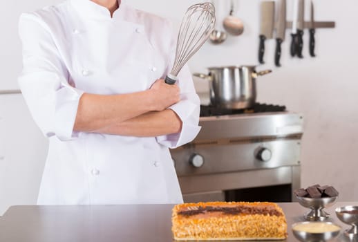 Pastry chef presenting a yolk and cream cake