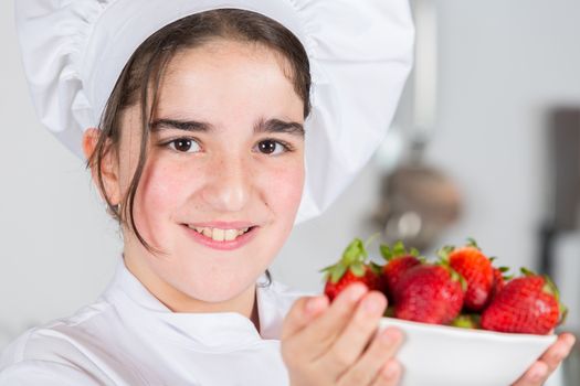 Teenage girls looking delicious fresh strawberries
