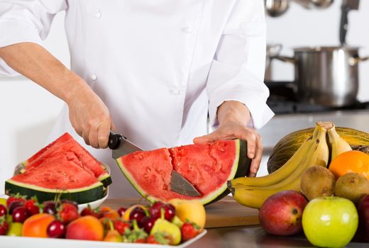Chef cutting a delicious sweet watermelon