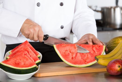 Chef cutting a delicious sweet watermelon