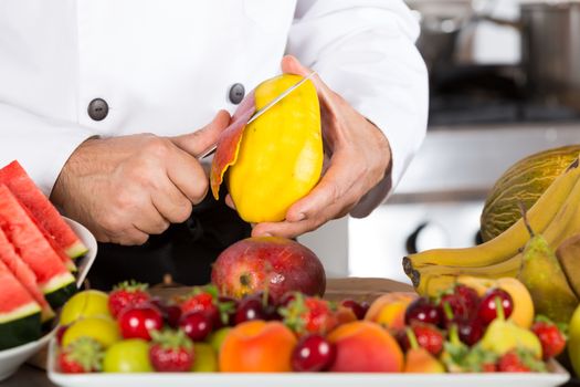 Chef cutting a delicious ripe mango