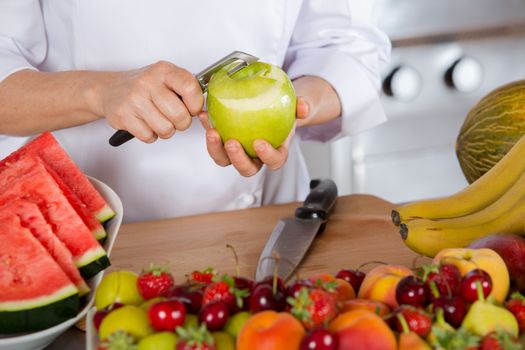 Chef cutting a sour apple green