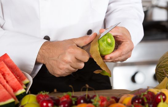 Chef cutting a delicious kiwi acid