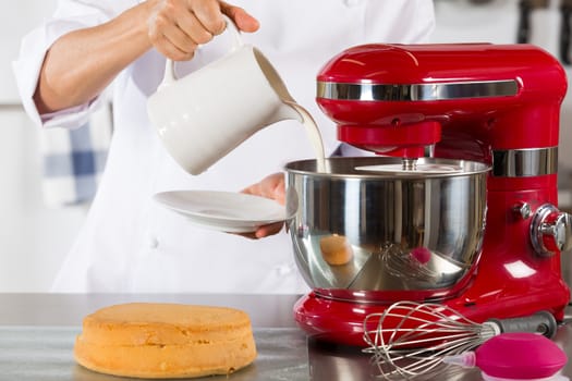 Chef preparing whipping cream to make a cake