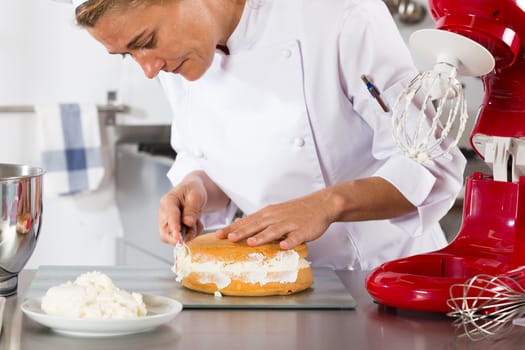 Chef decorating a delicious cake with cream