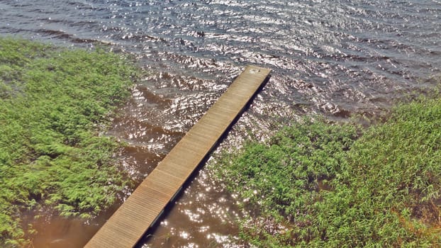 View from above on a wooden pier, on the lake shore.