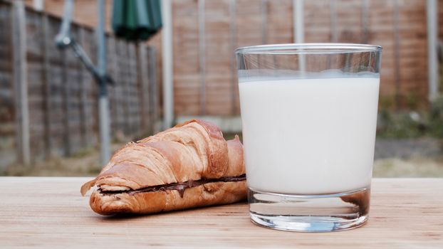 Delicious fresh and tasty chocolate croissant and white cold milk.