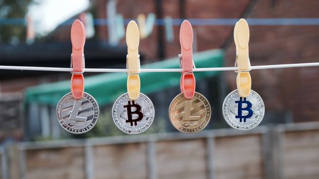 Digital currency physical silver and gold bitcoins and litecoins on the line.