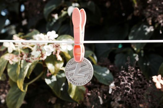 Digital currency physical silver Litecoin coin on the white line.