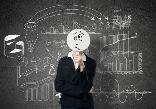 Businesswoman and graphs at background hiding her face behind mask