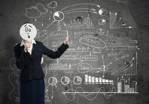 Businesswoman and graphs at background hiding her face behind mask