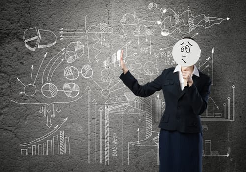 Businesswoman and graphs at background hiding her face behind mask