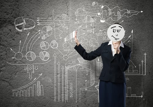 Businesswoman and graphs at background hiding her face behind mask