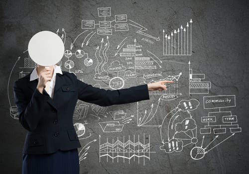Businesswoman and graphs at background hiding her face behind mask