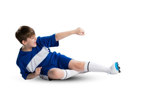Boy football player in blue uniform against white background