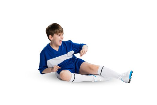 Boy football player in blue uniform against white background