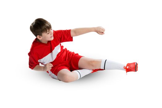 Boy football player in red uniform against white background