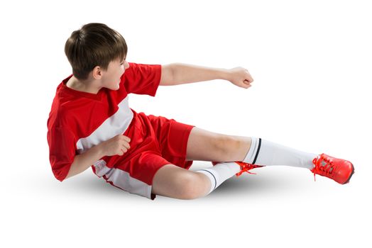 Boy football player in red uniform against white background