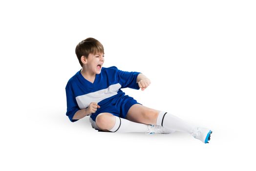 Boy football player in blue uniform against white background