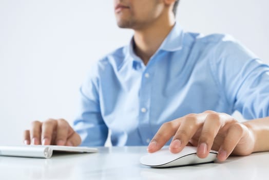 Young man sitting at desk and working on computer