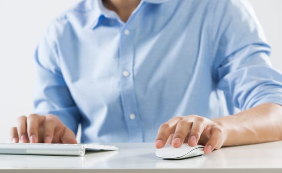 Young man sitting at desk and working on computer