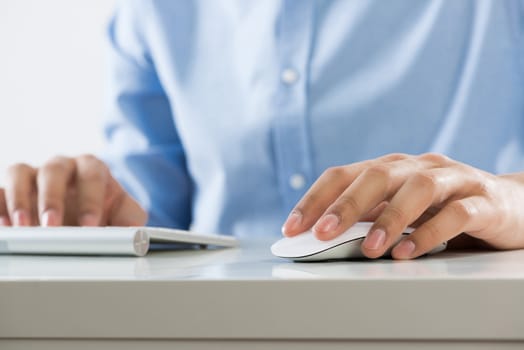 Young man sitting at desk and typing on keyboard