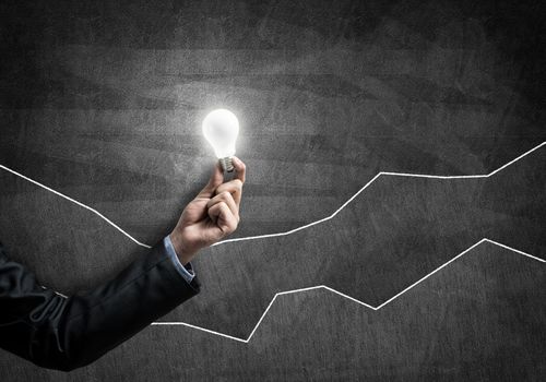 Conceptual image with light bulb diagrams and graphs