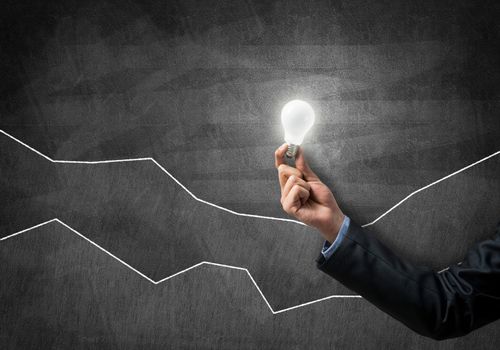 Conceptual image with light bulb diagrams and graphs