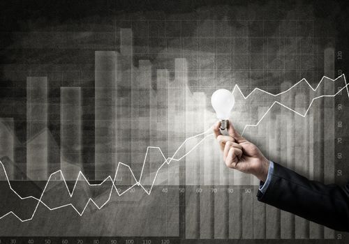 Conceptual image with light bulb diagrams and graphs