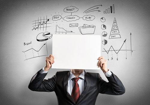 Businessman hiding his face behind sheet of paper