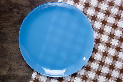 Plate and napkin on a wooden table