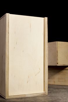 Light wooden boxes on a dark background